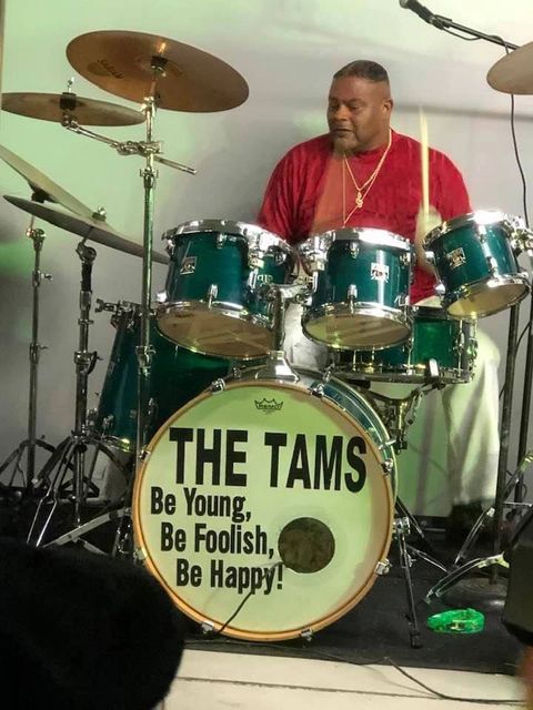 A drummer from The Tams playing on stage