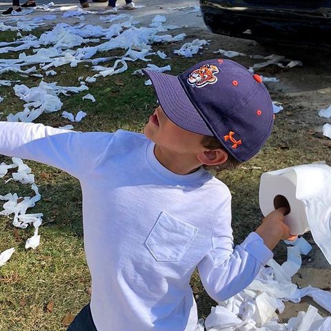 A young Auburn fan rolling Toomer's Corner after a win